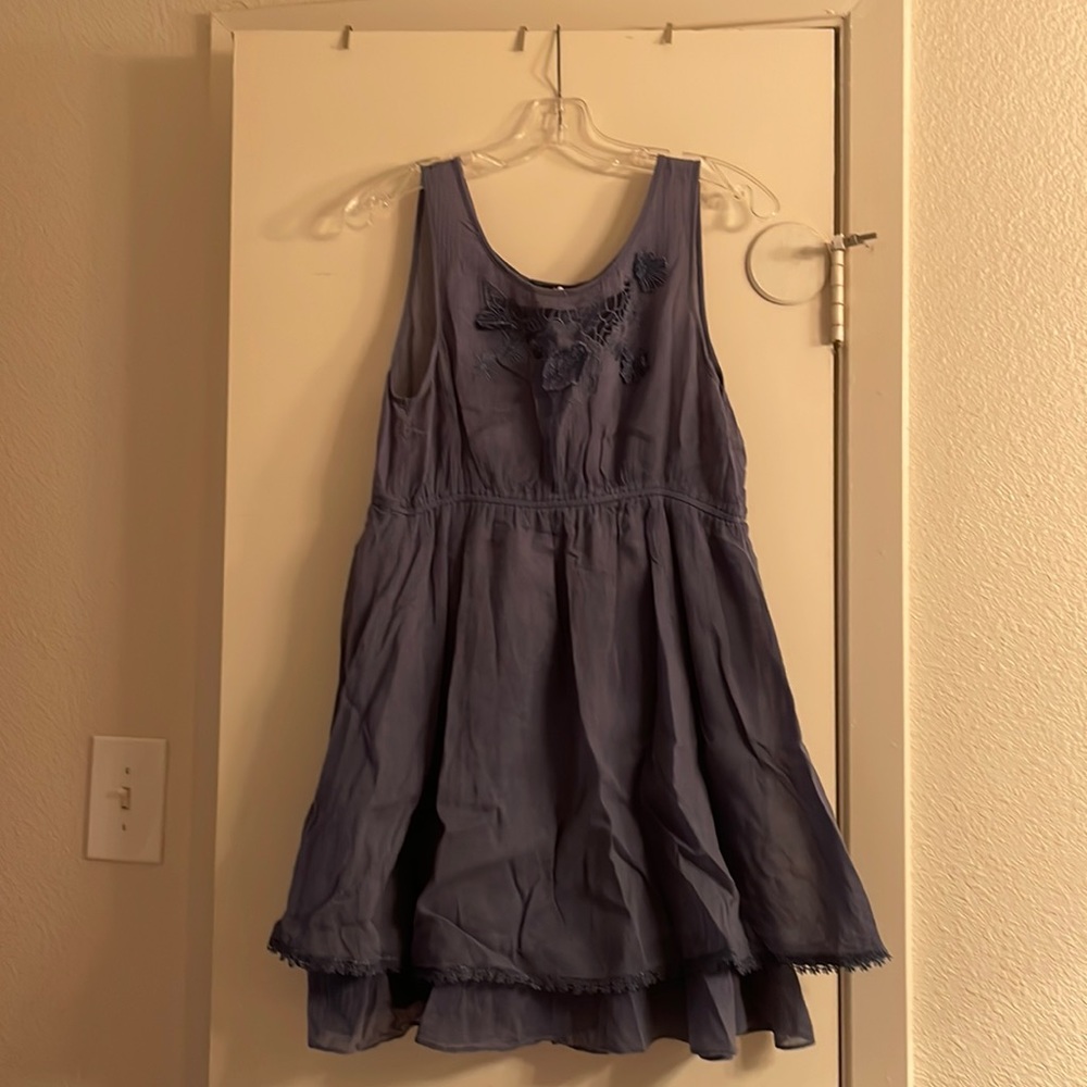 Blue sleeveless dress with floral details on top
